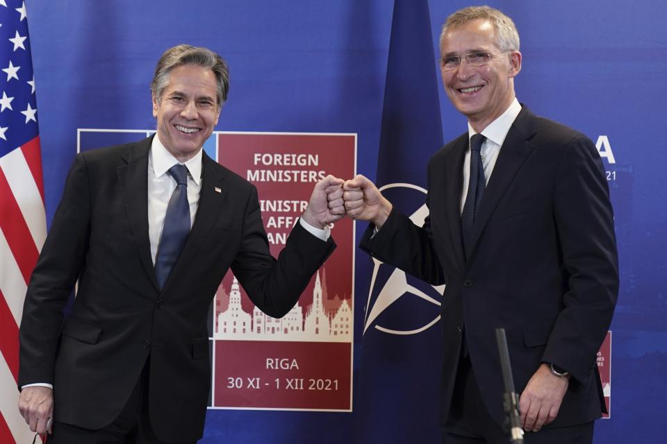 U.S. Secretary of State Antony Blinken, left, and NATO Secretary General Jens Stoltenberg greet each other as they speak to the media during NATO Foreign Ministers meeting in Riga, Latvia Tuesday, Nov. 30, 2021. (AP Photo/Roman Koksarov, Pool)