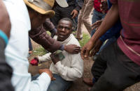 A man holds his South African identity document after being attacked by a mob in Pretoria, South Africa, February 24, 2017. REUTERS/James Oatway