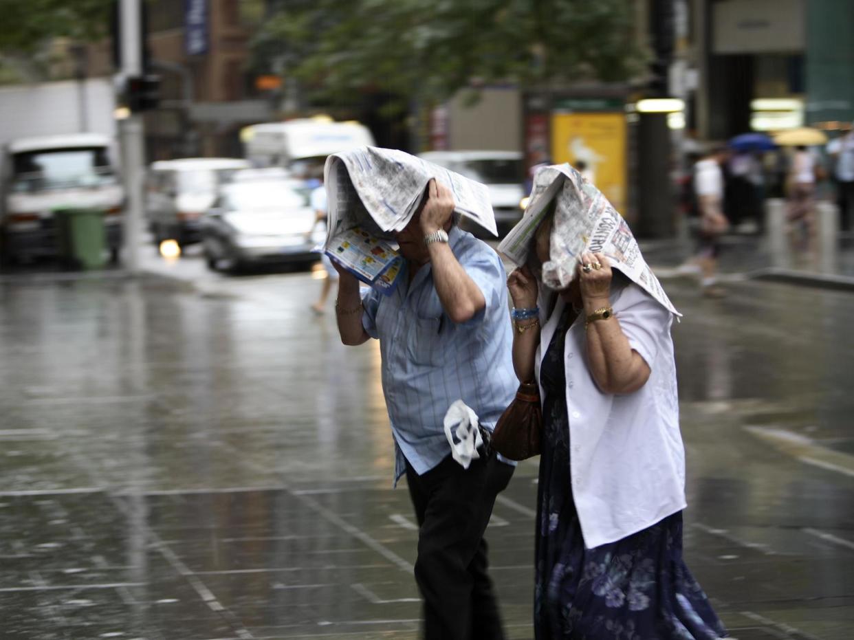 Stock photo of two people caught in the rain: Getty Images