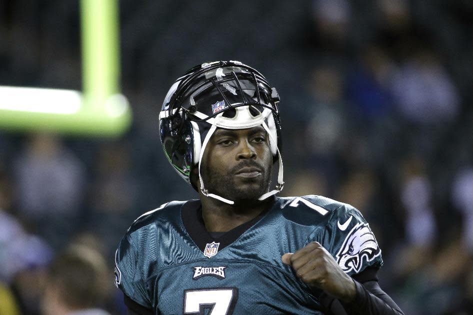 FILE - In a Dec. 22, 2013 file photo, Philadelphia Eagles' Michael Vick warms up before the first half of an NFL football game between the Philadelphia Eagles and the Chicago Bears, in Philadelphia. The New York Jets signed quarterback Michael Vick and released Mark Sanchez on Friday, March 21, 2014. Vick was a free agent after spending the last five seasons with the Phialdelphia Eagles. (AP Photo/Matt Rourke, File)
