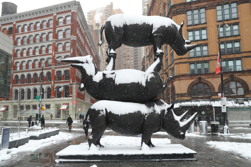 <p>“The Last Three” rhino sculpture is covered in snowfall in Astor Place, New York City on March 21, 2018. The incredible 17-foot-tall interactive artwork is being created to raise critical awareness about rhino conservation. (Photo: Gordon Donovan) </p>