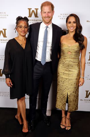 <p>Kevin Mazur/Getty Images</p> Doria Ragland, Prince Harry and Meghan Markle (wearing Johanna Ortiz) at the Ms. Foundation Women of Vision Awards in May 2023