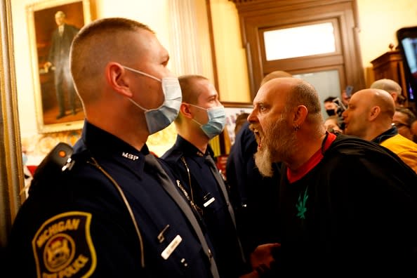 Protestors try to enter the Michigan House of Representative chamber and are being kept out by the Michigan State Police after the American Patriot Rally organised by Michigan United for Liberty protest for the reopening of businesses on the steps of the Michigan State Capitol in Lansing.