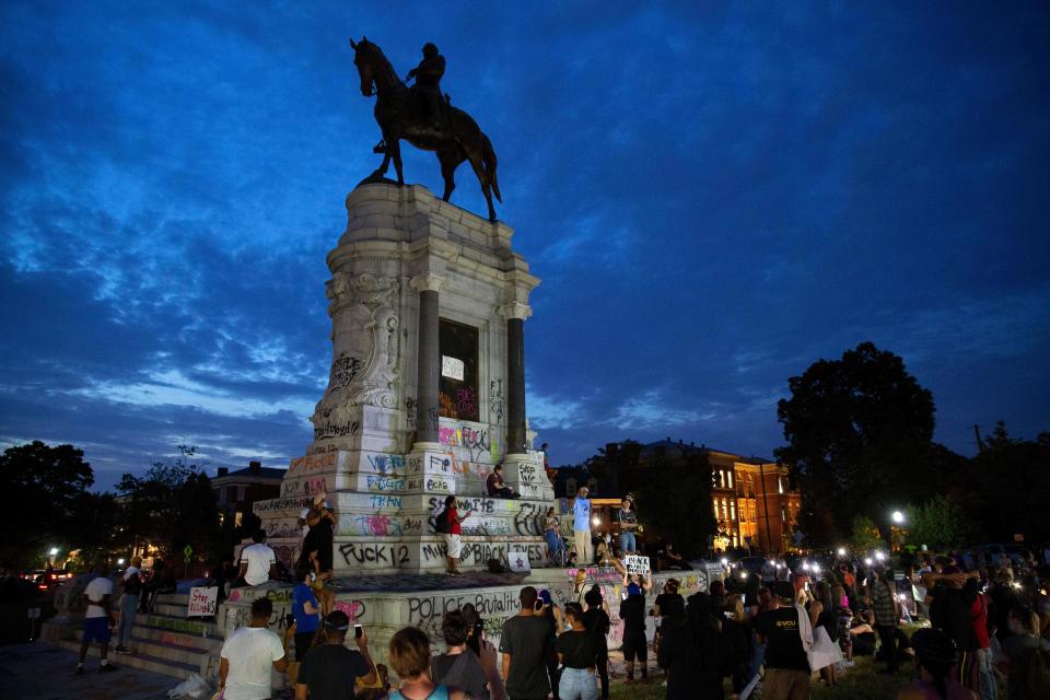 People gather around the Robert E. Lee statue on Monument Avenue in Richmond, Virginia, on June 4, 2020 amid protests over the death of George Floyd in police custody. / Credit: RYAN M. KELLY