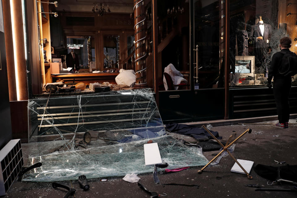 A man stops in front of a vandalized tailor’s shop during a demonstration by the “yellow vests” movement in Paris, France, Dec. 8, 2018. (Photo: Benoit Tessier/Reuters)