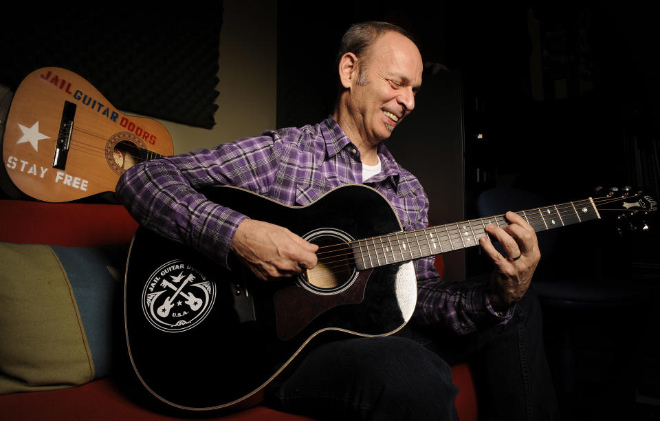 In this Jan. 16, 2012 photo, guitarist Wayne Kramer, founder of the band the MC5, plays one of the instruments that will be provided to jail inmates as part of the Jail Guitar Doors USA initiative at his recording studio in Los Angeles. The Jail Guitar Doors program provides instruments to inmates who are using music as a means of achieving rehabilitation. (AP Photo/Chris Pizzello)