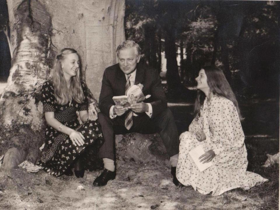 Adams reading 'Watership Down' with his two daughters, Juliet and Ros