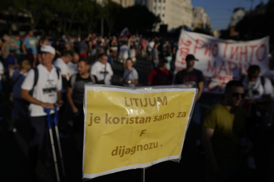 People attend a protest against pollution and the exploitation of a lithium mine in the country, in Belgrade, Serbia, Saturday, Aug. 10, 2024. Thousands were gathering Saturday at a rally against lithium mining in Serbia despite government warnings of alleged planned unrest designed to topple the government of populist President Aleksandar Vucic. The banner reads 'lithium is good only for F diagnosis'. (AP Photo/Darko Vojinovic)