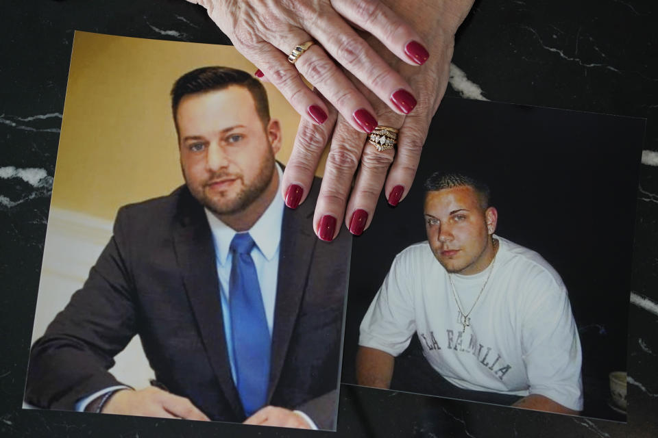 FILE - Cheryl Juaire holds photos of her sons, both of whom died from overdoses, Sean Merrill, left, and Corey Merrill, after making a statement during a hearing in New York on March 10, 2022. A federal appeals court cleared the way Tuesday, May 30, 2023, for the maker of OxyContin to settle thousands of legal claims tied to the opioid epidemic while shielding the wealthy owners of Purdue Pharma, the Sackler family, from future lawsuits. (AP Photo/Seth Wenig, File)