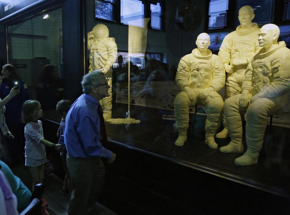 Ohio Governor Mike DeWine takes his  grandchildren Steven Dudukovich, 6, and Jean Dudukovich, 8, to see the butter sculptures of astronauts Neil Armstrong, Buzz Aldrin and Michael Collins at the Ohio State Fair in 2019.