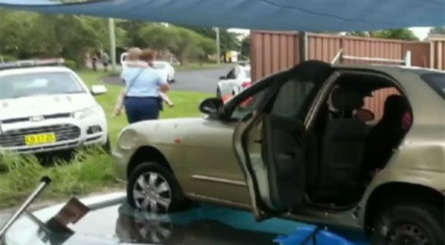 An officer comforts the little girl after her mother led police on a three-hour chase. Photo: 7 News