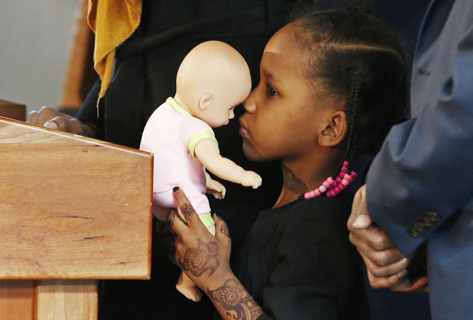 FILE - In this Feb. 3, 2017, file photo, four-year-old Somali refugee Mushkaad Abdi holds her doll as her mother, Samira Dahir, talks during a Minneapolis news conference one day after she was reunited with her family. Her trip from Uganda to Minnesota was held up by President Donald Trump's Jan. 27, 2017, order barring refugees from seven predominantly Muslim nations. Trump appears to be ignoring a deadline to establish how many refugees will be allowed into the United States in 2021, raising uncertainty about the future of the 40-year-old resettlement program that has been dwindling under the administration. (AP Photo/Jim Mone, File)