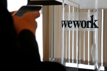FILE PHOTO: A guest attends the opening ceremony of WeWork Hong Kong flagship location in Hong Kong, China February 23, 2017. REUTERS/Bobby Yip/File Photo