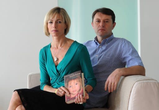 Kate and Gerry McCann, whose daughter Madeleine went missing from her family's holiday flat in the Algarve shortly before her fourth birthday in 2007, pose with their book 'Madeleine' on September 16, 2011 at a hotel in Hamburg. Portuguese authorities have said they have no new evidence that would give them cause to reopen an inquiry into the disappearance of Madeleine