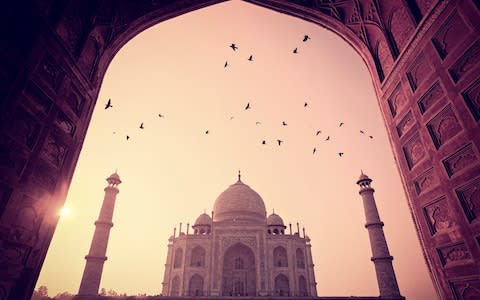 The sun sets over the Taj Mahal - Credit: Getty Images