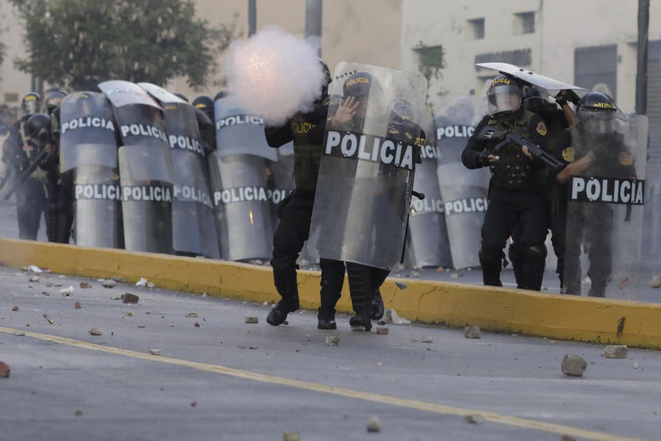 Police charge at anti-government protesters in downtown Lima, Peru, Tuesday, Jan. 24, 2023. Protesters are seeking the resignation of President Dina Boluarte, the release from prison of ousted President Pedro Castillo, immediate elections and justice for demonstrators killed in clashes with police. (AP Photo/Guadalupe Pardo)