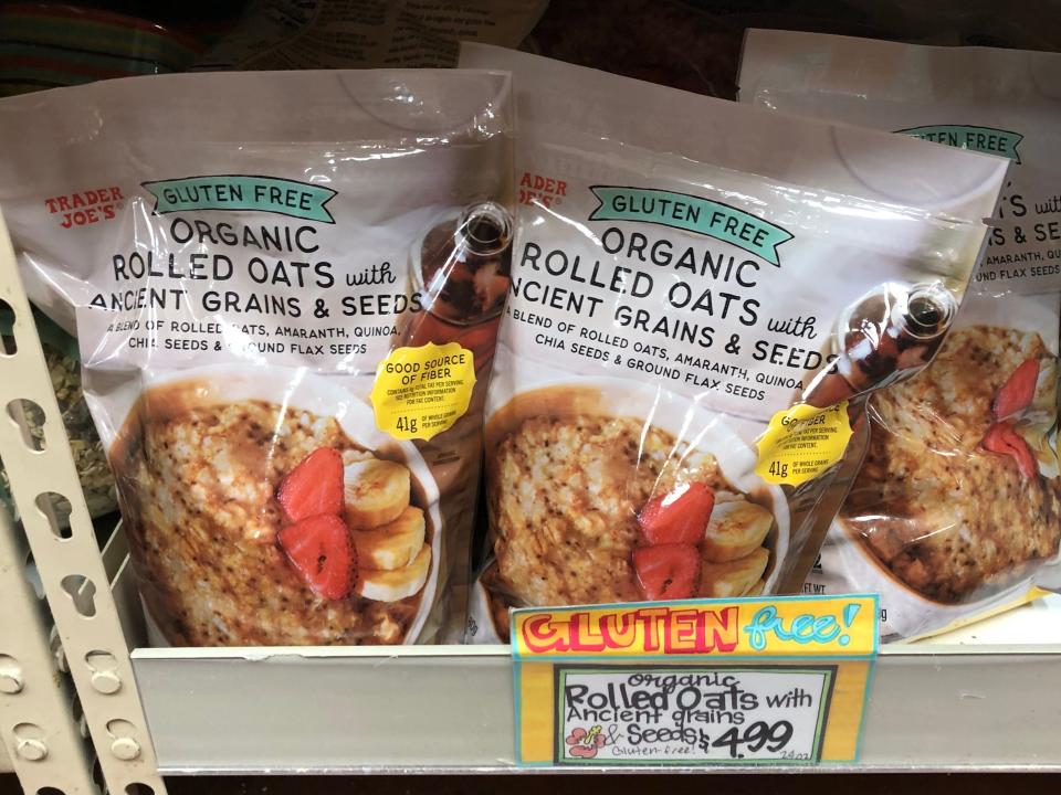 Bags of gluten-free organic rolled oats with ancient grains and seeds at Trader Joes. The price tag reads $4.99.