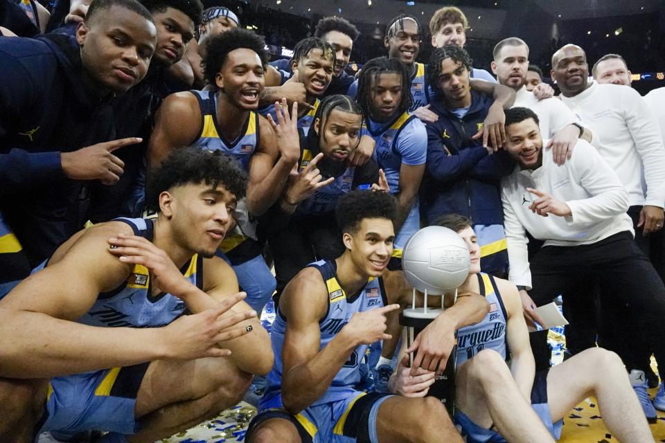 Marquette players celebrate after an NCAA college basketball game against St. John's Saturday, March 4, 2023, in Milwaukee. Marquette won 96-94. Marquette won the Big East Conference. (AP Photo/Morry Gash)