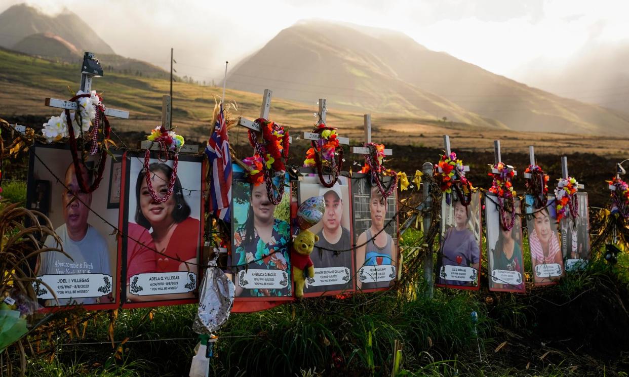 <span>Photos of victims of the Maui wildfire on 6 December 2023, in Lahaina, Hawaii.</span><span>Photograph: Lindsey Wasson/AP</span>