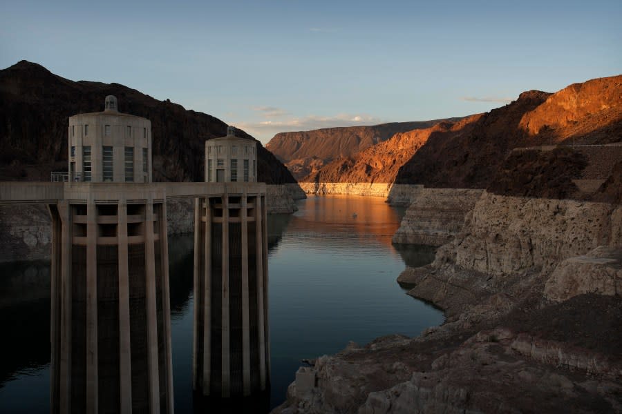 <em>FILE – A bathtub ring of light minerals shows the high water line of Lake Mead near water intakes on the Arizona side of Hoover Dam at the Lake Mead National Recreation Area Sunday, June 26, 2022, near Boulder City, Nev. (AP Photo/John Locher, File)</em>