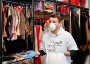 Ukrainian fashion designer Frolov demonstrates protective coveralls in his show room in Kiev