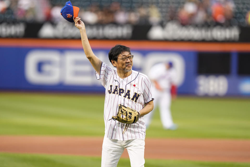 The Japanese consul-general in New York, Ambassador Mikio Mori, waves before throwing out a ceremonial first pitch before a baseball game between the New York Mets and the Colorado Rockies, Thursday, Aug. 25, 2022, in New York. (AP Photo/Frank Franklin II)