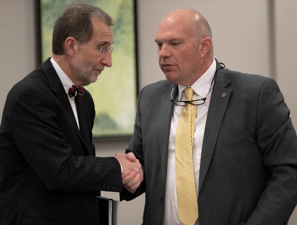 UNC Board of Governors chairman Harry Smith, right, shakes hands with UNC Interim President Dr. Bill Roper following the Board of Governors meeting on Friday, January 25, 2019 in Chapel Hill, N.C.