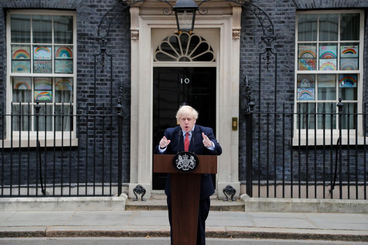 British Prime Minister Boris Johnson makes a statement, flanked by children's drawings of rainbows supporting the National Health Service (NHS) displayed in windows, on his first day back at work at Downing Street in London, England after recovering from a bout with the coronavirus that put him in intensive care on Monday, April 27, 2020. The highly contagious COVID-19 coronavirus has impacted on nations around the globe, many imposing self isolation and exercising social distancing when people move from their homes.