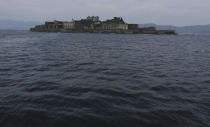 FILE - In this June 29, 2015, file photo, Hashima Island, commonly known as Gunkanjima, which mean "Battleship Island," is seen off Nagasaki, Nagasaki Prefecture, southern Japan. Gunkanjima was among the settings for a dark chapter in Japan’s history, when hundreds of thousands of people were brought from the Korean Peninsula and other Asian nations to work in logging, in mines, on farms and in factories as forced labor. (AP Photo/Eugene Hoshiko, File)
