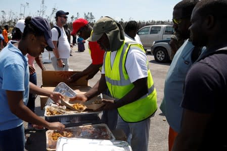 A volunteer delivers food during an evacuation operation after Hurricane Dorian hit the Abaco Islands in Treasure Cay