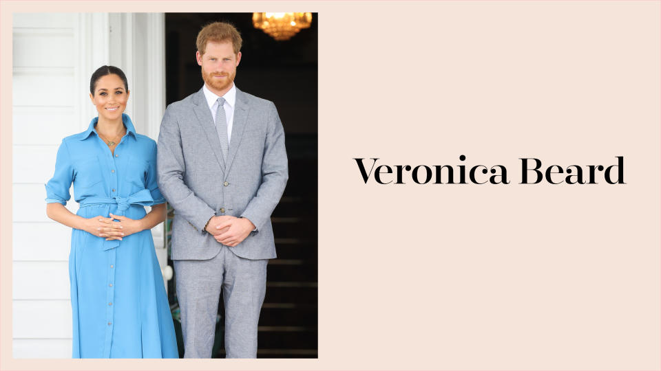 Meghan Markle wears a sky-blue shirtdress by Veronica Beard alongside Prince Harry in a gray suit while in Tonga during the royal tour. (Photo: Getty Images)