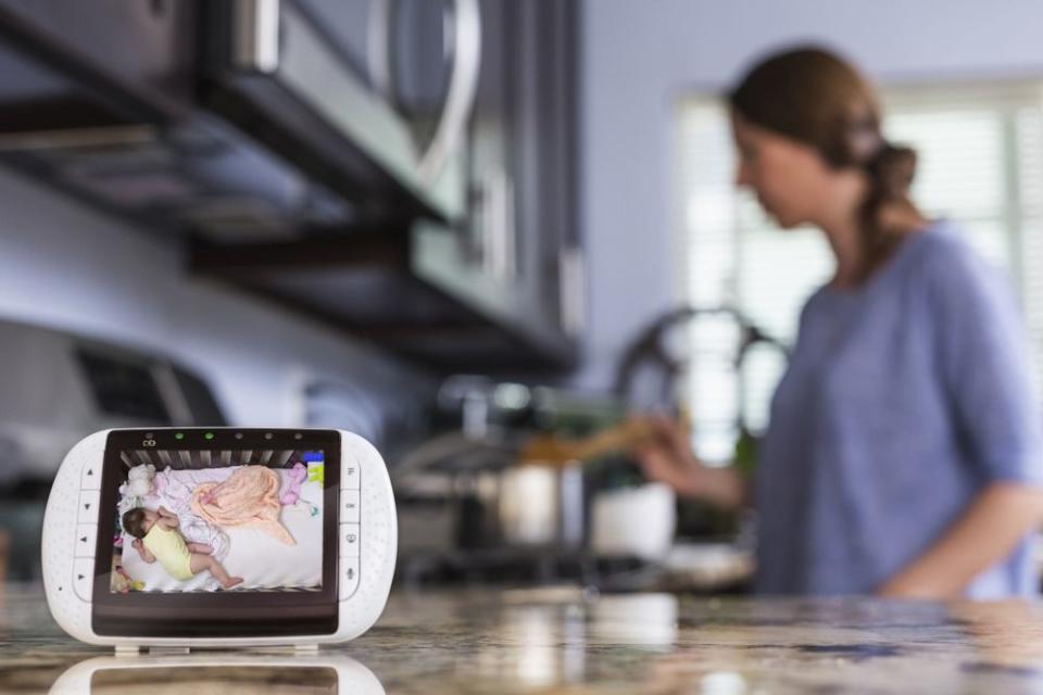 Mom in kitchen with baby monitor