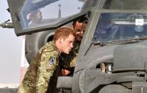 Britain's Prince Harry examines the interior of an Apache helicopter at Camp Bastion in Helmand Province, Afghanistan on September 7, 2012. Prince Harry said he killed Taliban fighters during his stint as a helicopter gunner in Afghanistan, it can be reported after he completed his tour of duty Monday