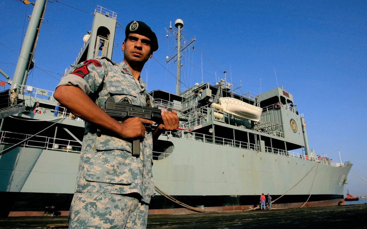 File image of an Iranian special forces soldier on guard outside a naval vessel - AFP/AFP