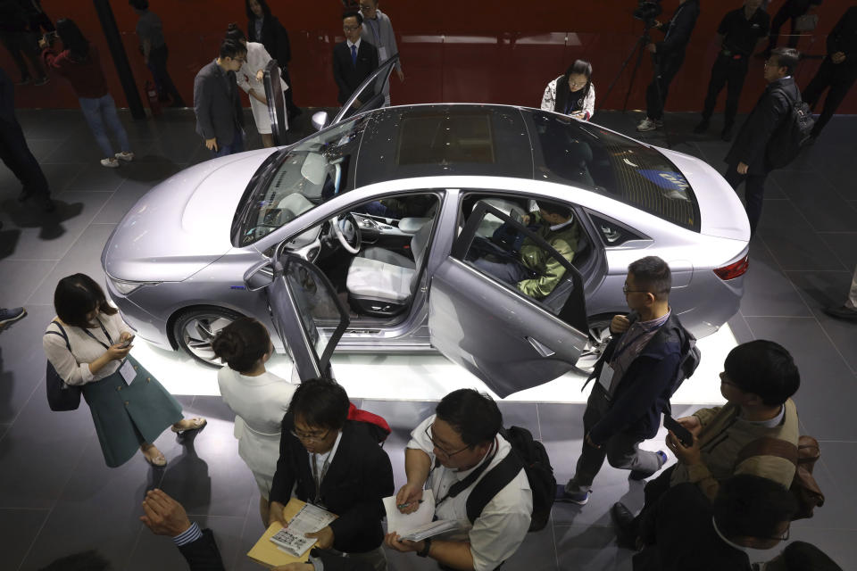 Chinese automaker Geely Auto displays a sedan from its new electric brand Geometry during the Auto Shanghai 2019 show in Shanghai Tuesday, April 16, 2019. Automakers are showcasing electric SUVs and sedans with more driving range and luxury features at the Shanghai auto show, trying to appeal to Chinese buyers in their biggest market as Beijing slashes subsidies that have propelled demand. (AP Photo/Ng Han Guan)