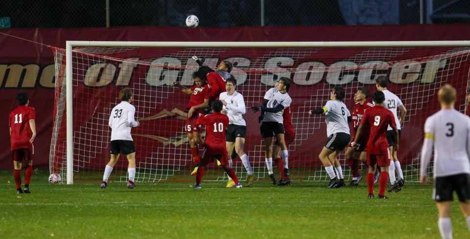 Goshen goalkeeper Tomas Hernandez-Quiroz punches the ball away on a corner kick during Wednesday night’s regional game against Penn at Goshen.