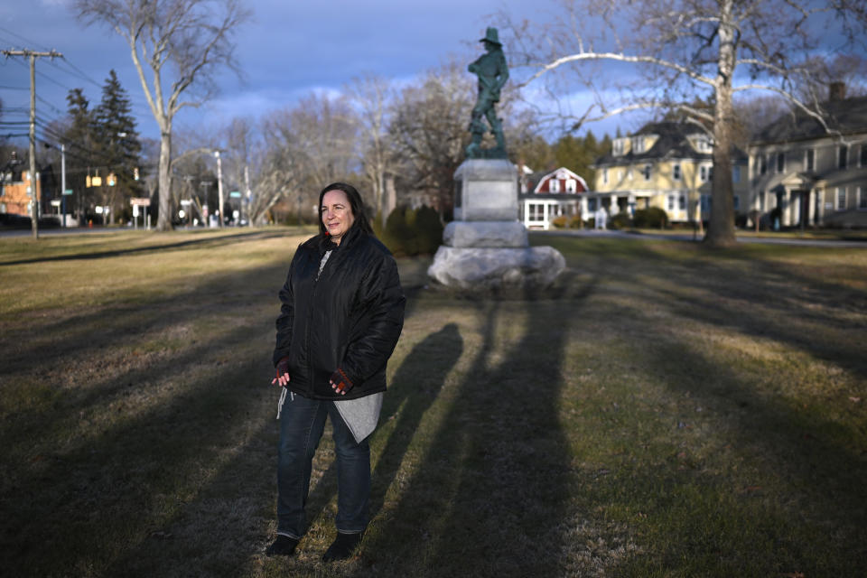 In this Tuesday, Jan. 24, 2023 photo, Beth Caruso, author and co-founder of the CT Witch Trial Exoneration Project, which was created to clear the names of the accused, stands on the old town green in Windsor, Conn., where in 1651, an accident during a local militiamen training exercise led to the accusation of witchcraft and hanging of Lydia Gilbert. Now, more than 375 years later, amateur historians, researchers and descendants of the accused witches and their accusers, from across the U.S., are urging Connecticut officials to officially acknowledge this dark period of the state's colonial history and posthumously exonerate those wrongfully accused and punished. (AP Photo/Jessica Hill)