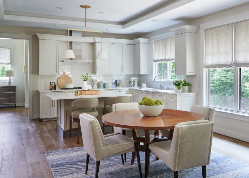 Gray mid-toned flooring in kitchen/dining room.