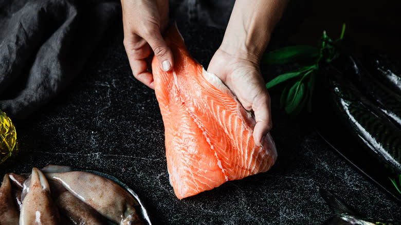 Chef holding salmon