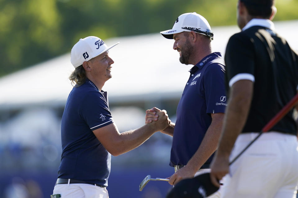 Cameron Smith, of Australia, left, celebrates with his teammate Marc Leishman, of Australia, after winning the PGA Zurich Classic golf tournament at TPC Louisiana in Avondale, La., Sunday, April 25, 2021. (AP Photo/Gerald Herbert)