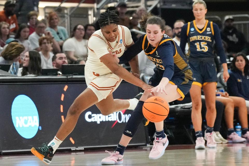 Texas forward Madison Booker and Drexel guard Erin Sweeney fight for control of the ball during Friday's first-round game at Moody Center. The Longhorns won 82-42 despite a rare off night shooting the ball by Booker.