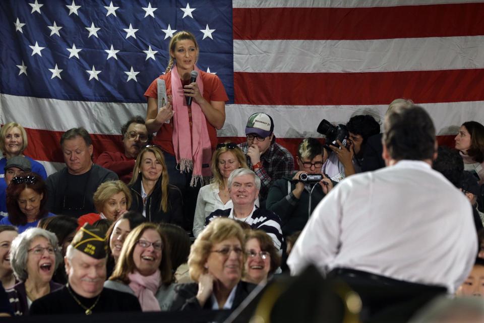 The crowd laughs as a crying Conni Freestone, of Point Pleasant, N.J., tells Gov. Chris Christie, right, back to camera, at a town hall meeting, Thursday, Feb. 20, 2014, in Middletown, N.J., that her mother really liked him. Freestone told Christie she is very sad because her mother's home was severely damaged by Superstorm Sandy and now her mother died last Saturday without ever being able to move back to her home. (AP Photo/Mel Evans)