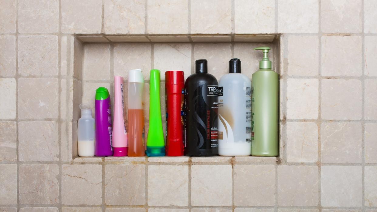 Bayonne, New Jersey, USA- September 16, 2013: Shampoos conditioners and liquid soaps in shower in wall of shower.