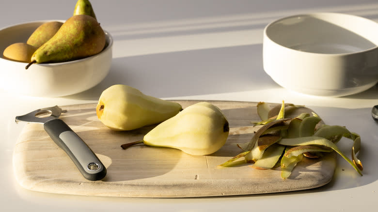 peeled pears on a board