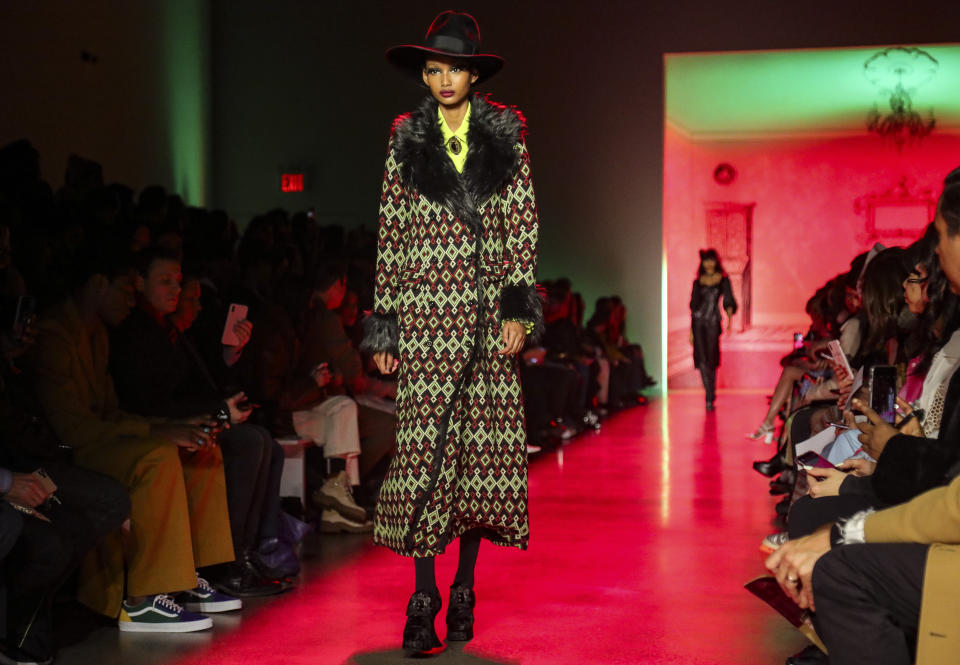 A model walks the runway in a creation by Anna Sui during New York's Fashion Week, Monday Feb. 10, 2020. (AP Photo/Bebeto Matthews)