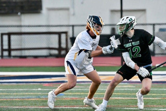 Ramsey's Justus Favata (1) applies pressure to Pascack Valley's Joe Dargan during a boys lacrosse match in Ramsey.