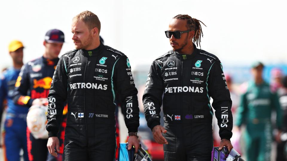 Valtteri Bottas and Lewis Hamilton walk together.