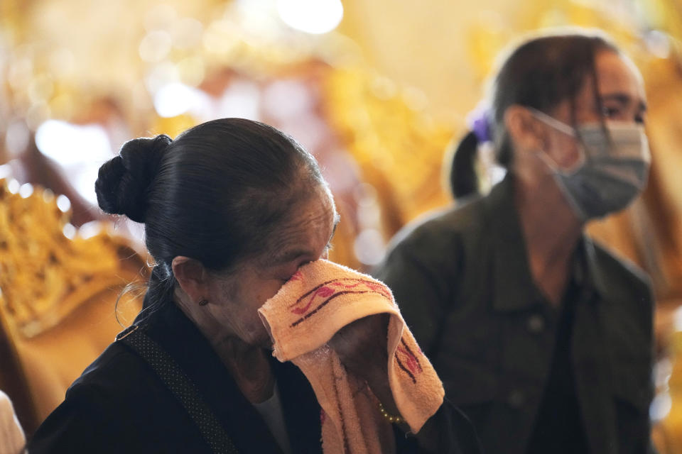 Family members cry during a funeral for Duangphet Phromthep, one of the 12 boys rescued from a flooded cave in 2018, at Wat Phra That Doi Wao temple in Chiang Rai province, Thailand, Sunday, March 5, 2023. The cremated ashes of Duangphet arrived in the far northern Thai province of Chiang Rai on Saturday where final Buddhist rites for his funeral will be held over the next few days following his death in the U.K. (AP Photo/Sakchai Lalit)