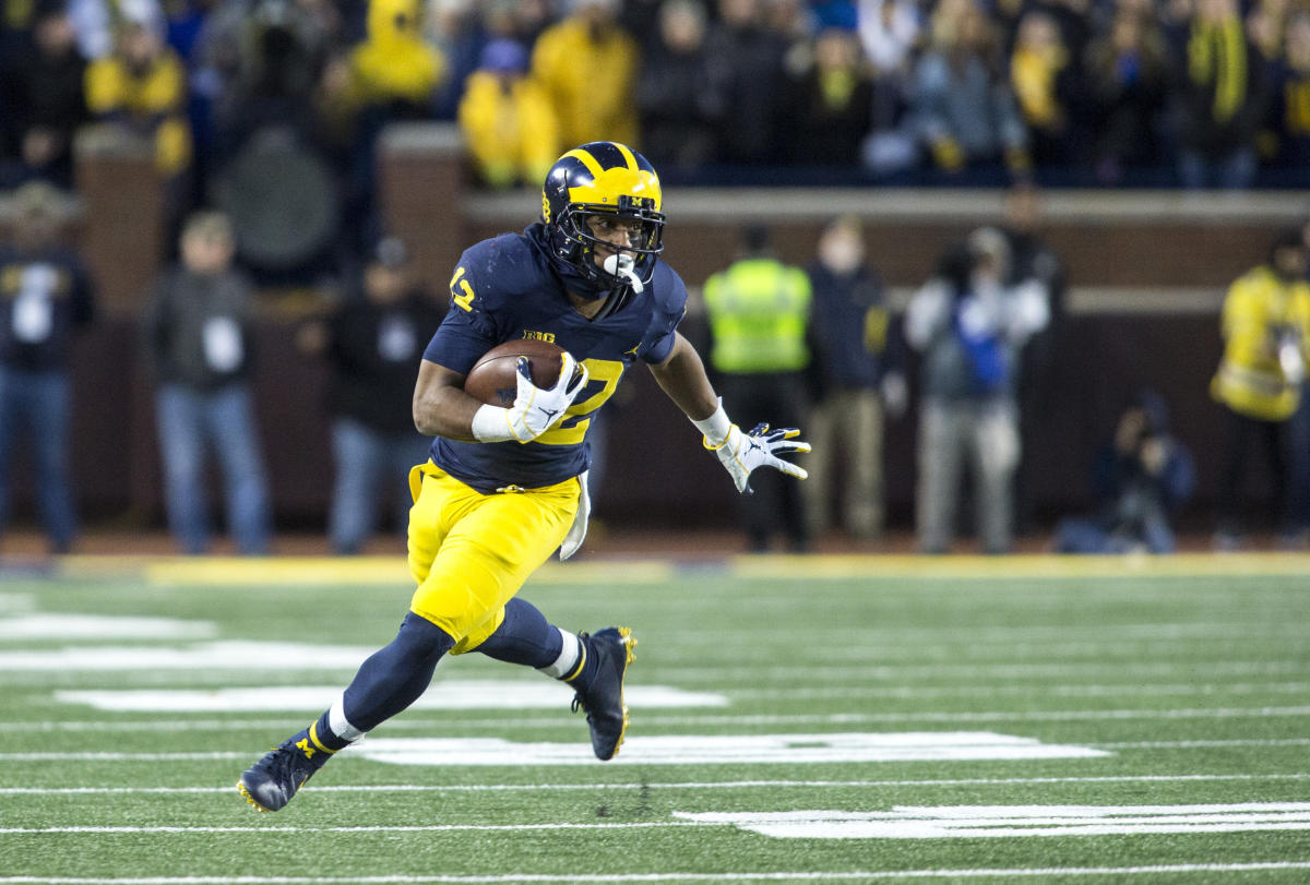 Michigan running backs Karan Higdon (22) and Chris Evans (12) stand in  their team bench in the fourth quarter of an NCAA college football game  against Wisconsin in Ann Arbor, Mich., Saturday