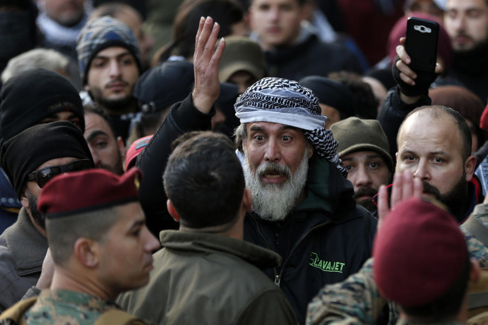 An anti-government protester argues with Lebanese army special forces during a protest against a parliament session to vote of confidence for the new government, in downtown Beirut, Lebanon, Tuesday, Feb. 11, 2020. (AP Photo/Hussein Malla)